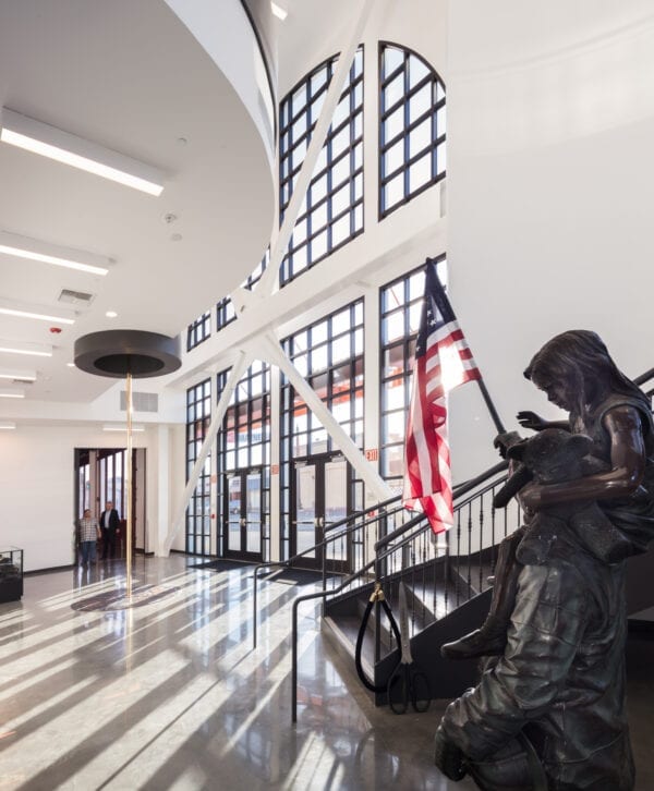 Bellflower Events Center lobby space with fireman's pole and statue.