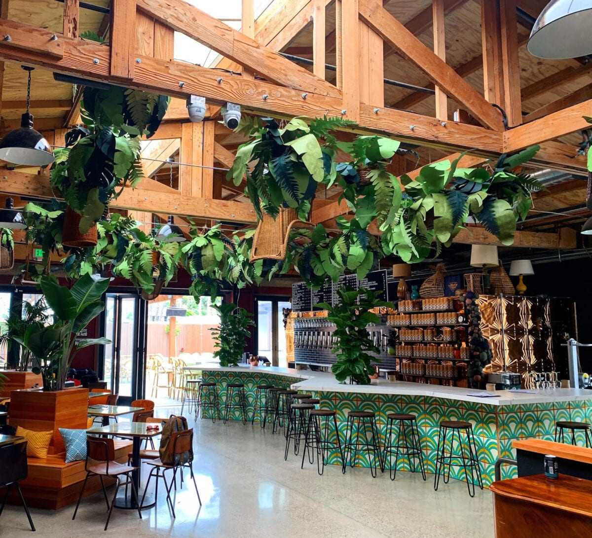 Modern Times Brewery Santa Barbara. Earthy bar and seating area with lots of greenery.