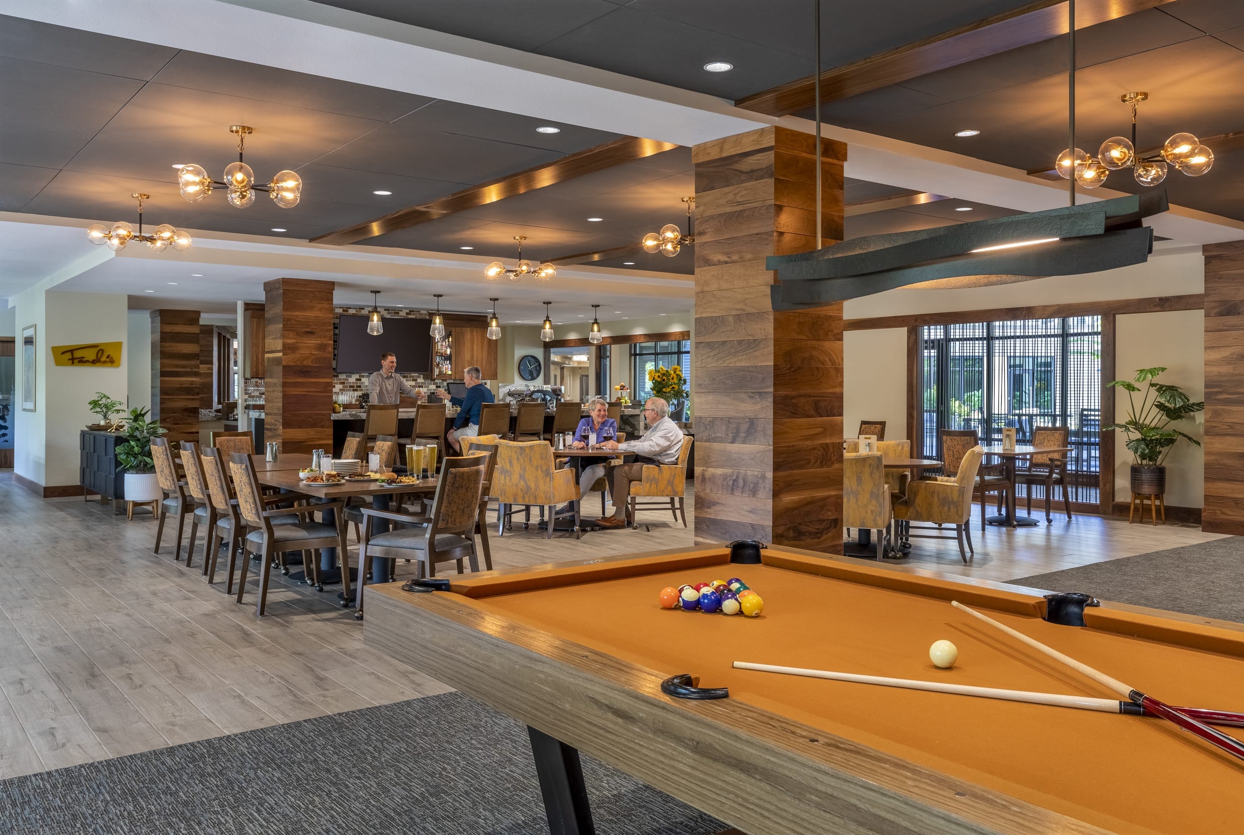 The Springs Living bar, seating area, and pool table.