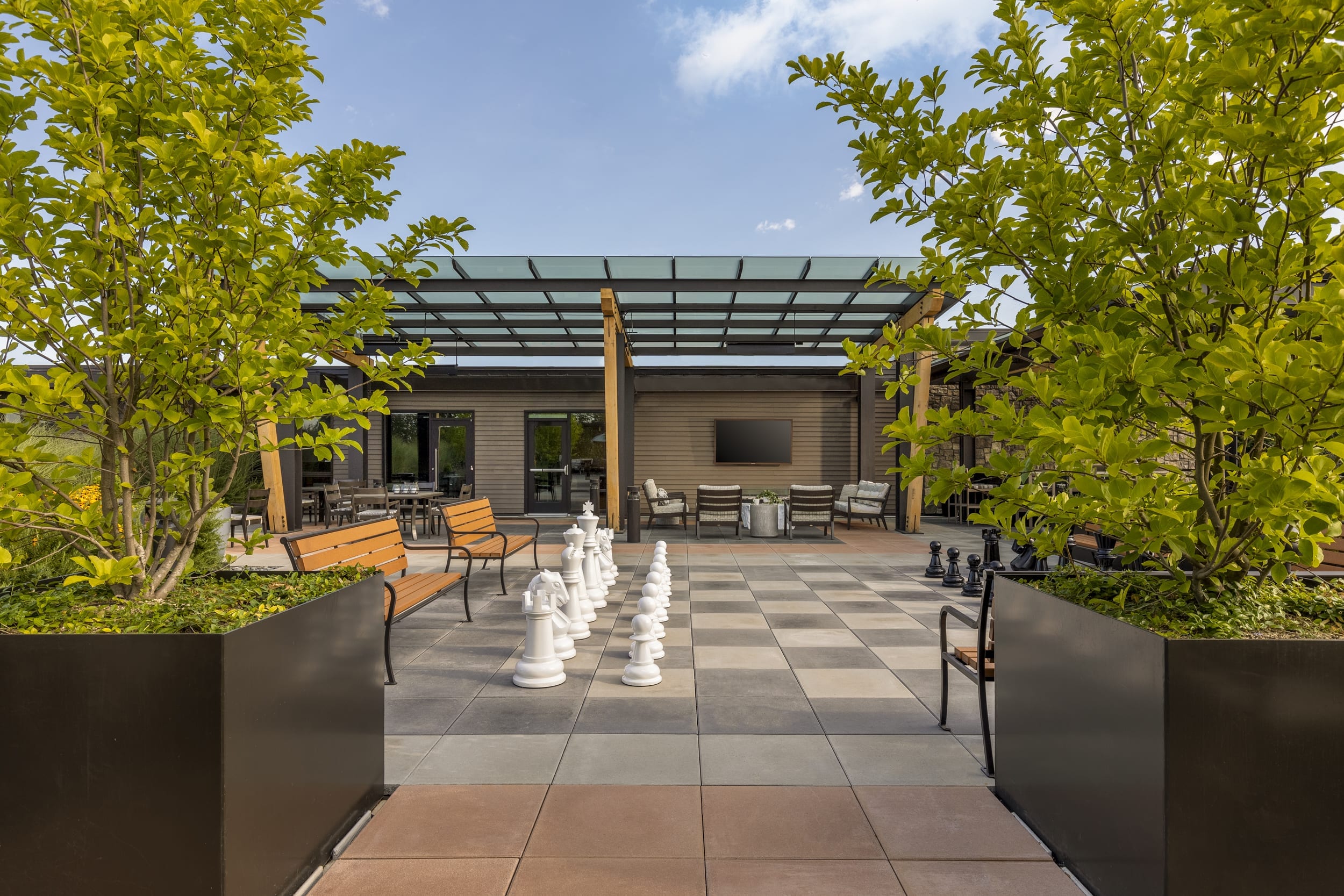 The Springs Living outdoor space with large chess set and outdoor seating.