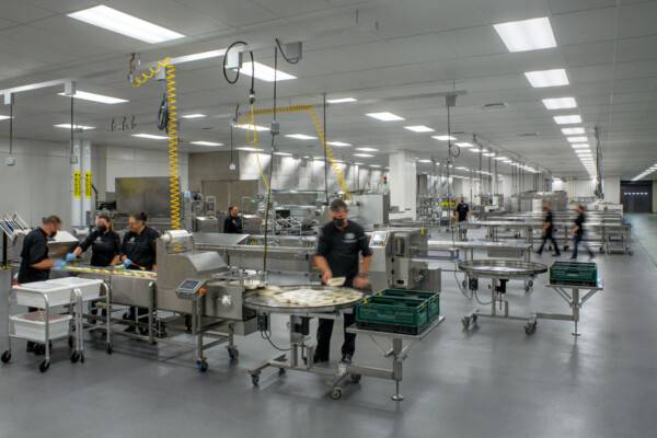 Sacramento City Unified School District. Chefs work with machinery to sort food.